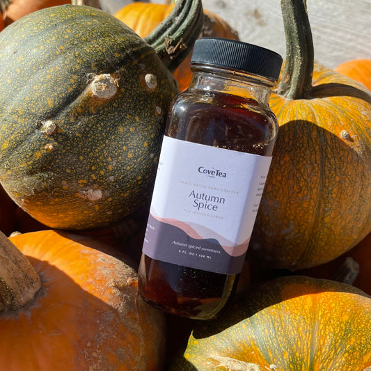 Artisanal Autumn Spice Syrup Posing in a Pile of Fresh Pumpkins